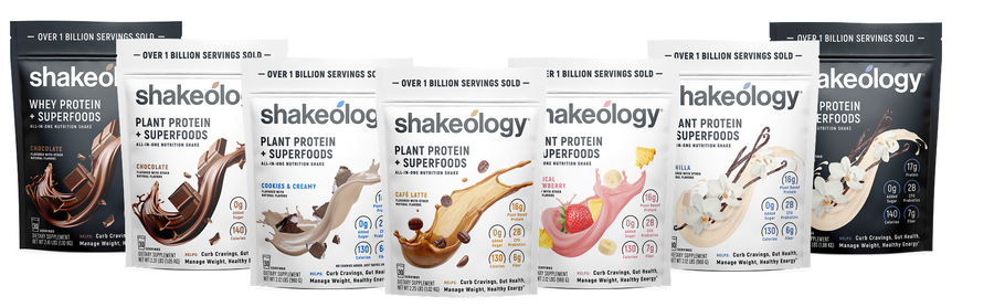 Five Shakeology superfood powder pouches in assorted flavors